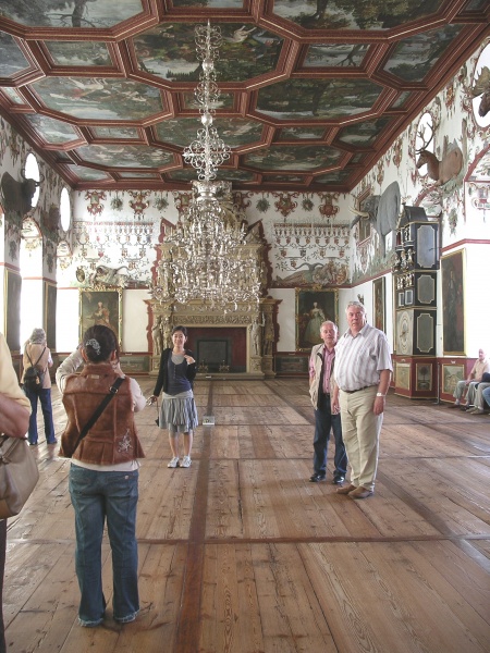 The Rittersaal (Knights' Hall) The walls are painted with the family's genealogy. Decorations include exotic animals, hunting scenes, and many tourists!