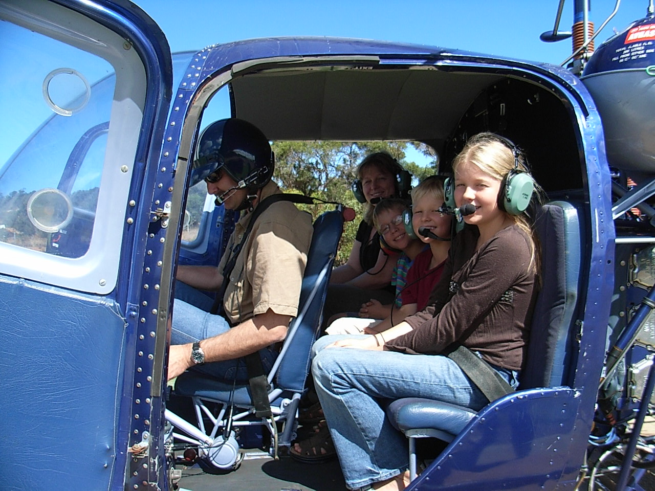 3 of our 5 children with me in the back seat of a Kawasaki helicopter. Andrew is piloting