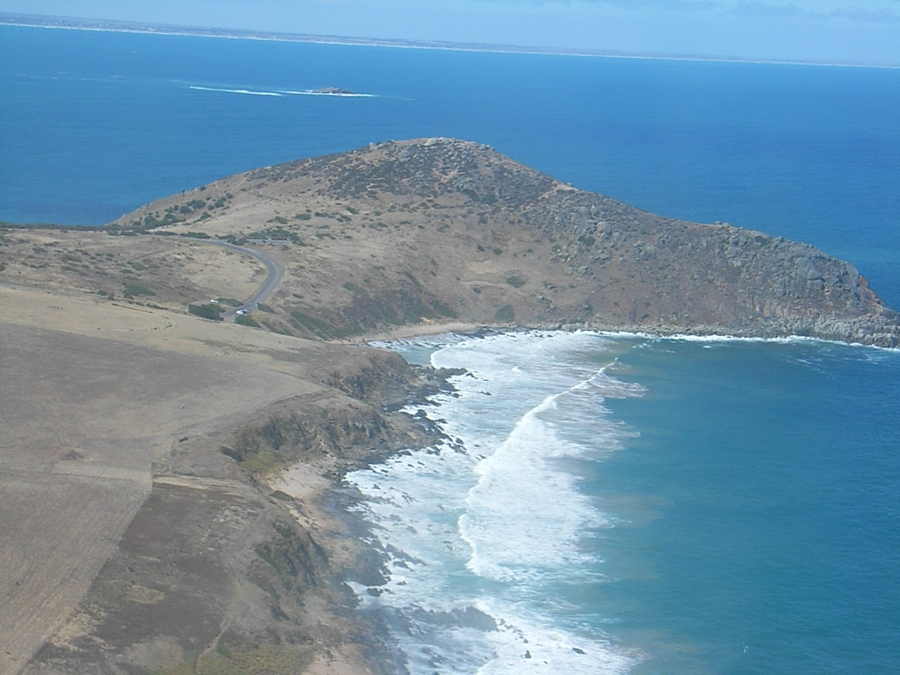 A granite headland, north of Victor Harbor. Windswept and bald, very rocky, very dangerous to swim near here. Not far from here is a great surfing beach.