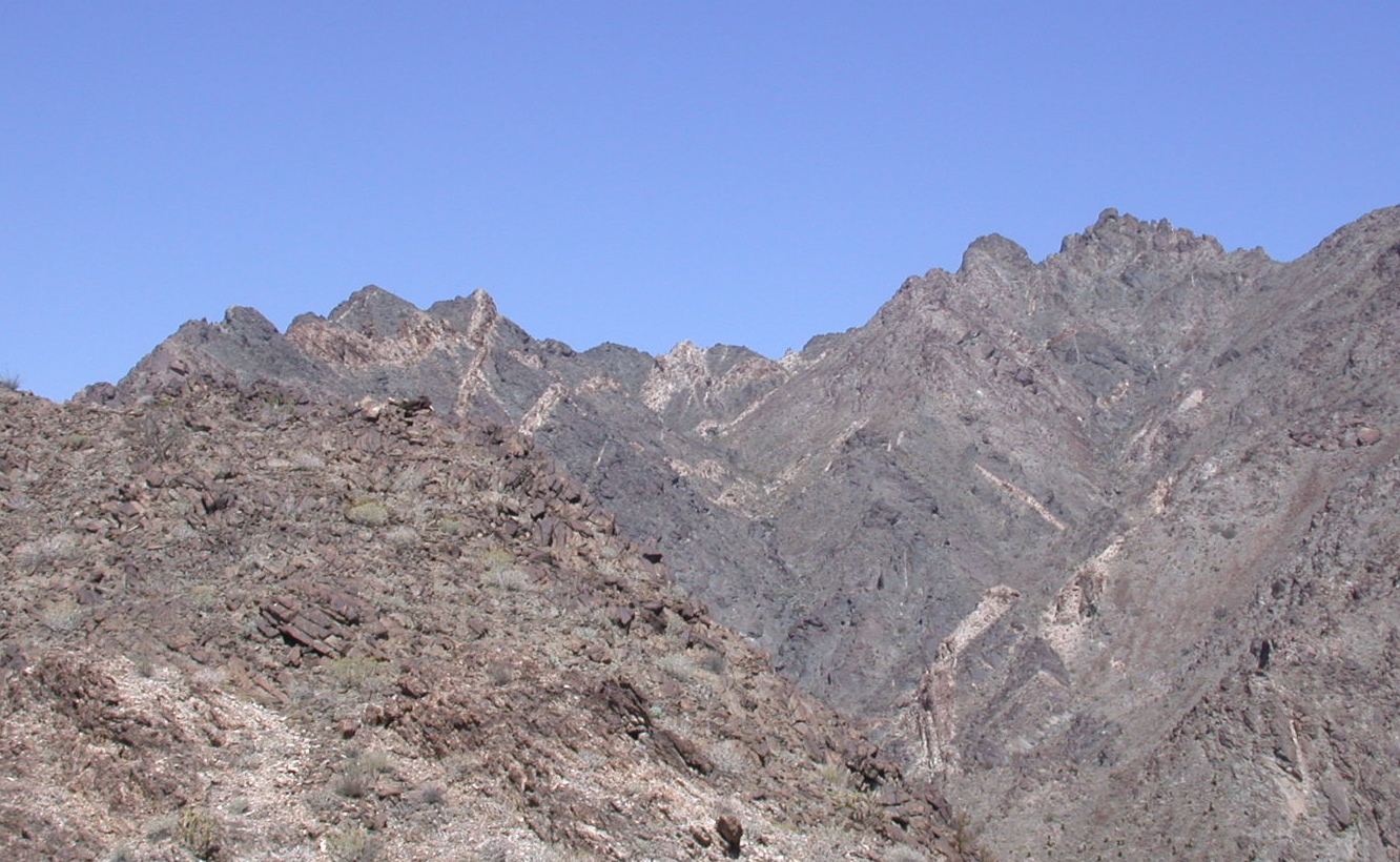 Look at the vivid difference between the stark rock mountain and blue sky.  Looking north from a gold mine on the side of a mountain at about 1300 feet.