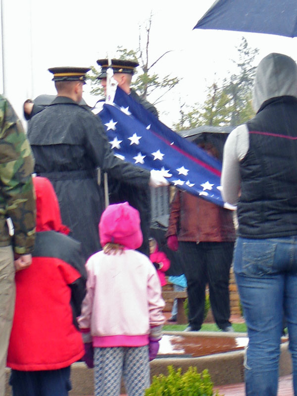 Children watch the honor guard, prepare to raise the flag