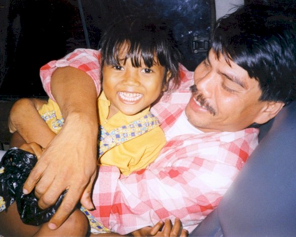 The bright little birthday girl; a little older than 4 years old here; with her even older cousin who is a skilled carpenter, plumber, electrician and builder - a very talented young man.