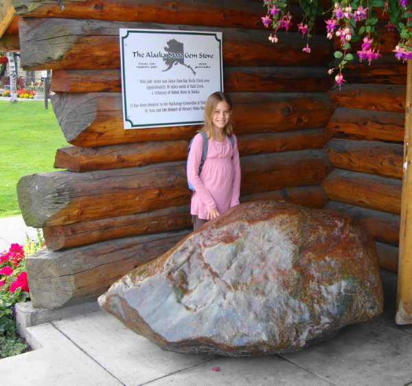 Katelyn is admiring a two+ ton jade rock at the entrance of the Anchorage Welcome Center.