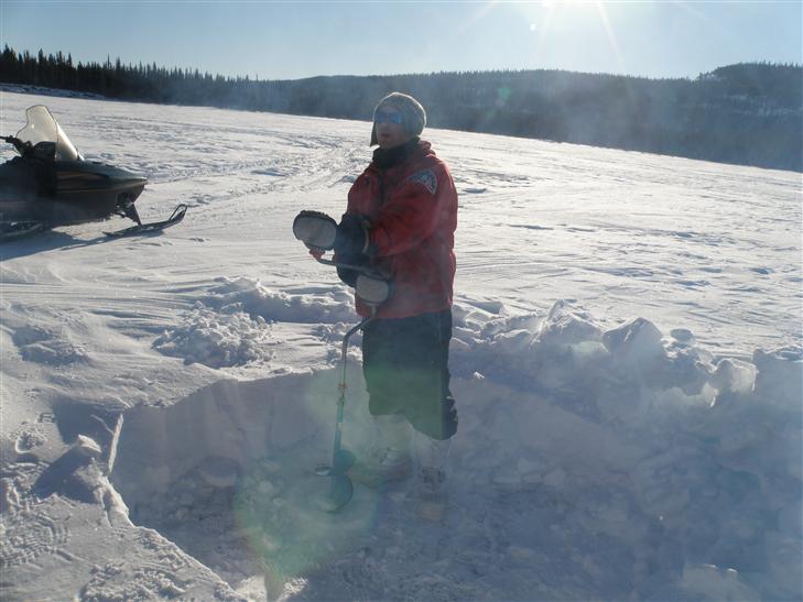 auguring the hole for ice fishing. 3 of us had lines in. Not one nibble.