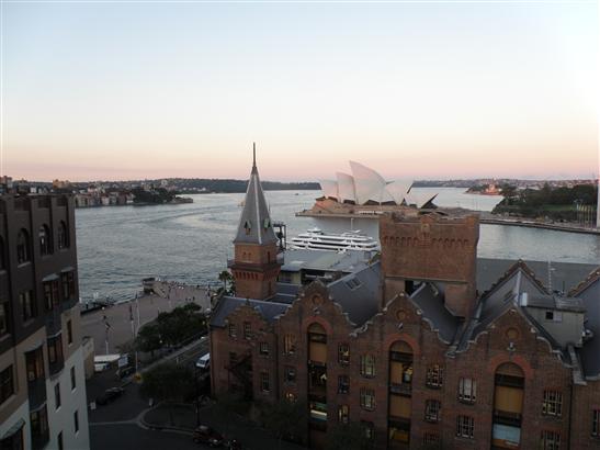 at dusk with a small cruise ship passing by.