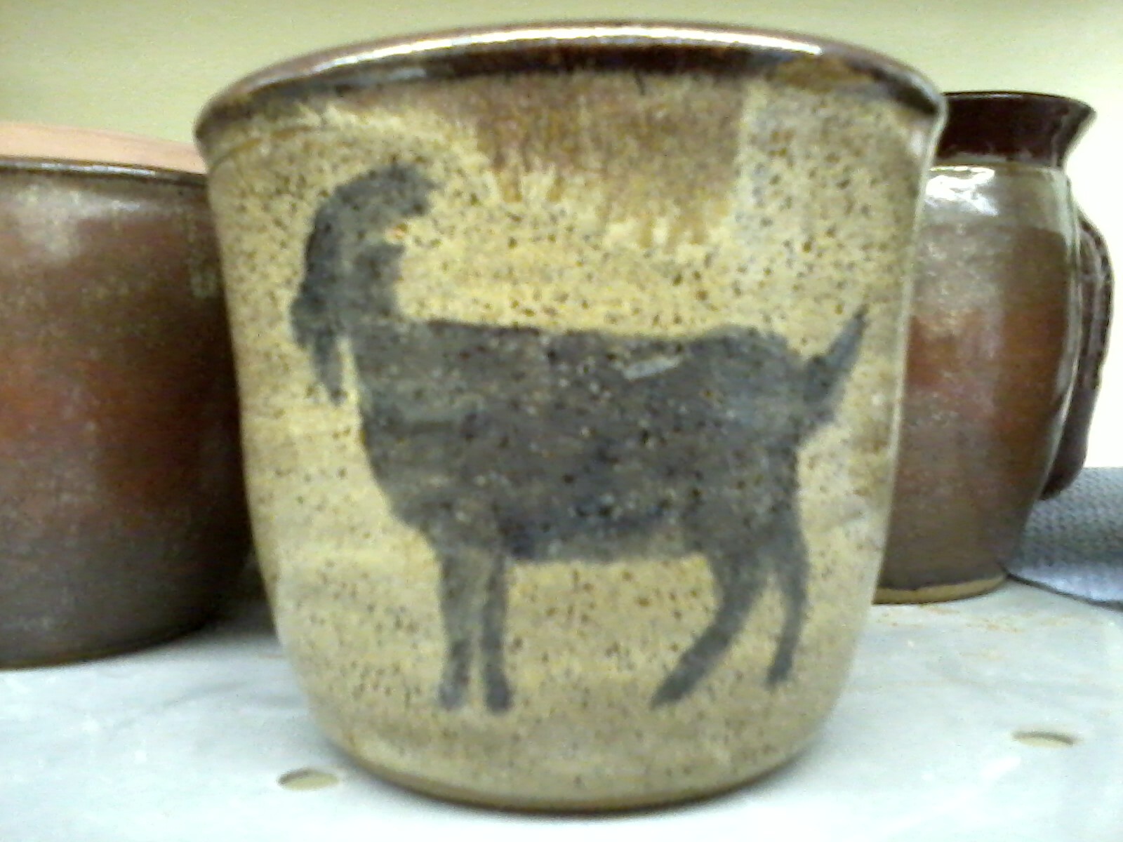 Hand painted goat on wheel thrown mug.