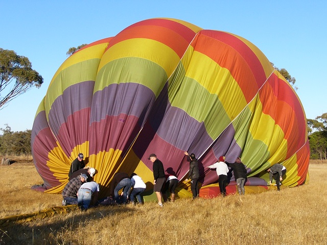 Some of the people helping to deflate the balloon