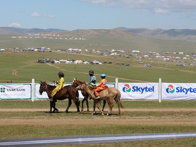 Next day we were at the Nadaam Festival races out in the hills to watch the young boys race. They are on their way to the starting line. It was sometimes hilarious watching other cars rushing to get out to the races from our bus. Thank goodness we had a good driver.