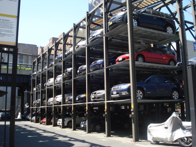 In this car park, they raise and lower the cars. If your car is on top, you can't get out until the other 2 cars have been collected by their owners.