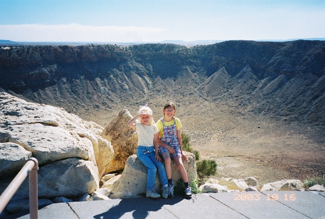 Granddaughters at top of Meteor Crater; the crater is more than a mile and a half across; the &quot;dots&quot; near the bottom are buildings; the NASA astronauts used this crater to test their spacesuits before their trip to land on the moon. This crater is privately owned and on a working cattle ranch, but they have an excellent visitors center with lots of information on meteor impacts throughout the world. 