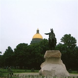 The status of 'The Horseman' pointing towards the dome of St Isaacs Cathedral.