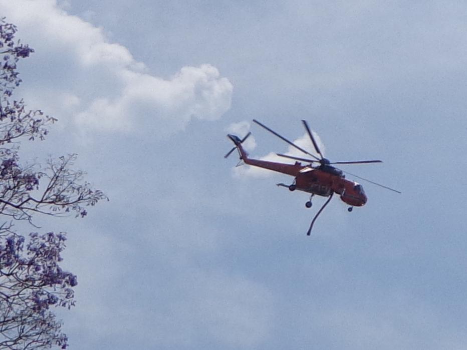 This is taken from my back yard. The helicopter has just dropped a load of water on the fire in the bush close to us.