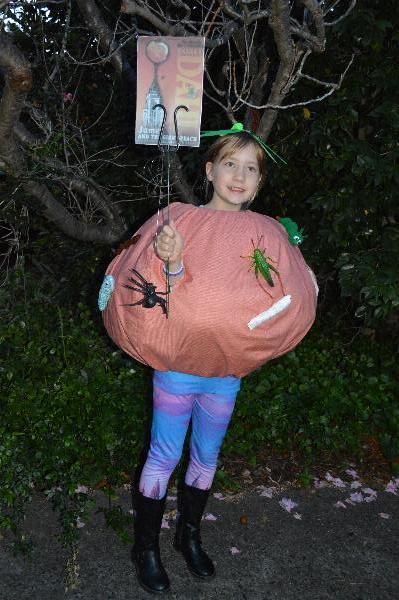 Laura dressed up as Roald Dahl's James and the Giant Peach. The boots hide the NY skyline. The peach lands on the Empire State Building in the story.