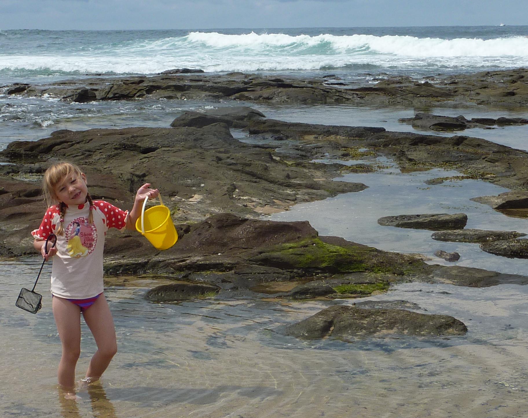 Laura having a wonderful time looking for shell and other things in the rock pools.