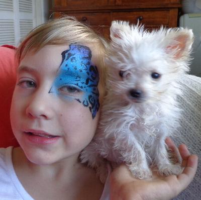 Laura with her painted face  holding Belinda's 3 month old tiny Pup. 