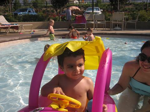 Kevin is very happy to drive his water car in the swimming pool.