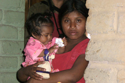 A young mother.  The dolls are also children's toys.