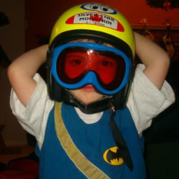 <b>Ethan (age 2.5) tries on his new downhill ski helmet & goggles.</b>