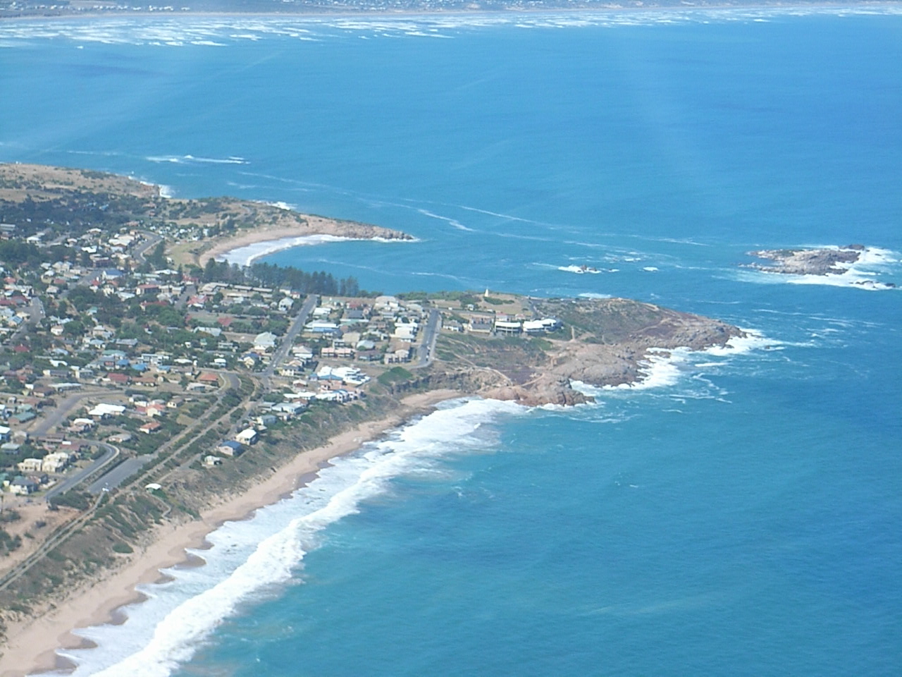 Looking at the township of Pt Elliot, the bay inbtween the headlands is called Horseshoe Bay. It is a very safe swimming beach.