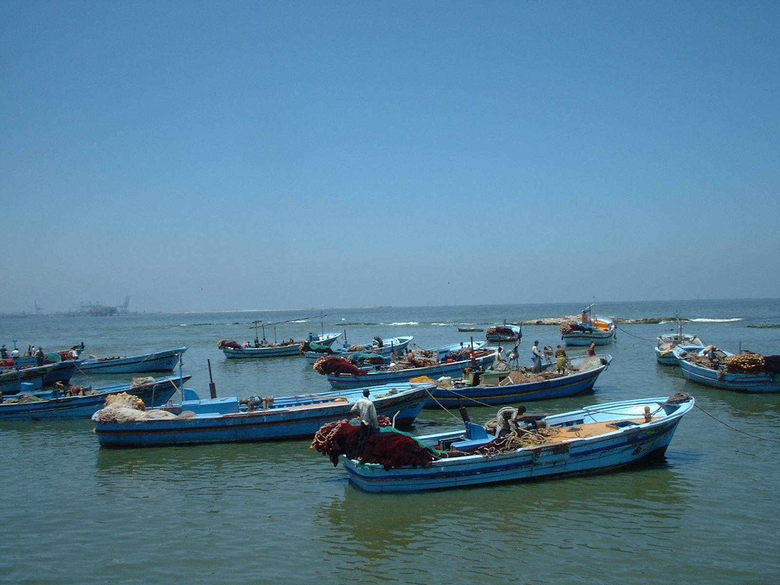 The place in Alexandria, where the Nile meets the Mediterranean Sea. Fishermen uploading their catch.