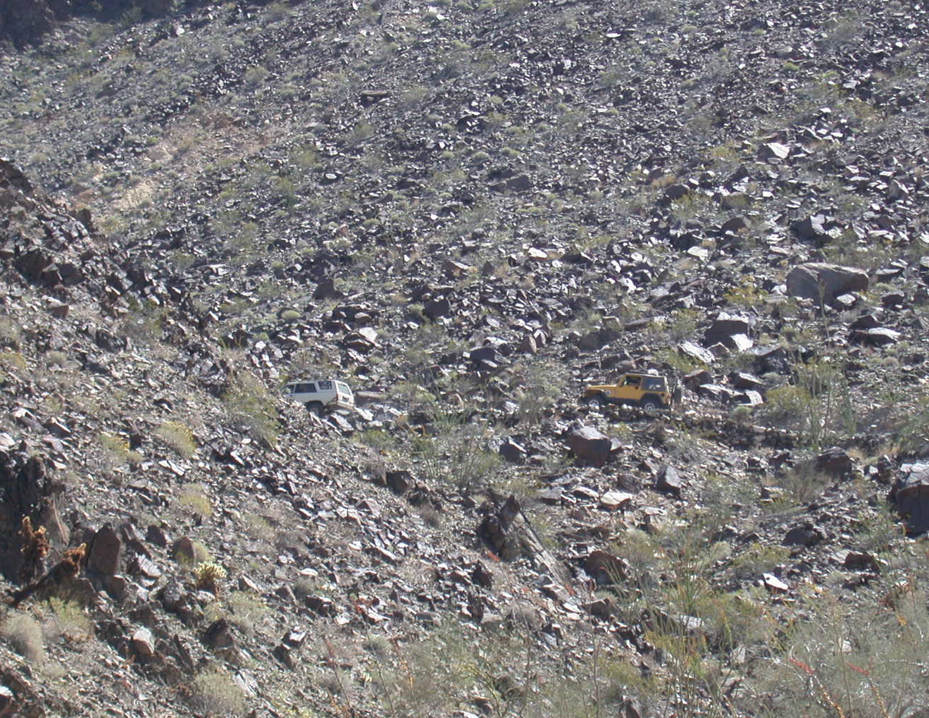 You have to look close to see the two Jeeps going up the trail on the side of the mountain.  Yuma Foothills, Woodcutter Pass.