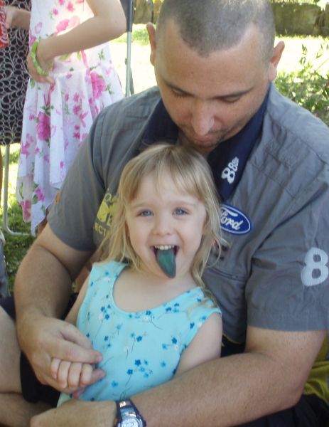 Chloe shows off her blue tongue to her Dad (from eating a lollipop).