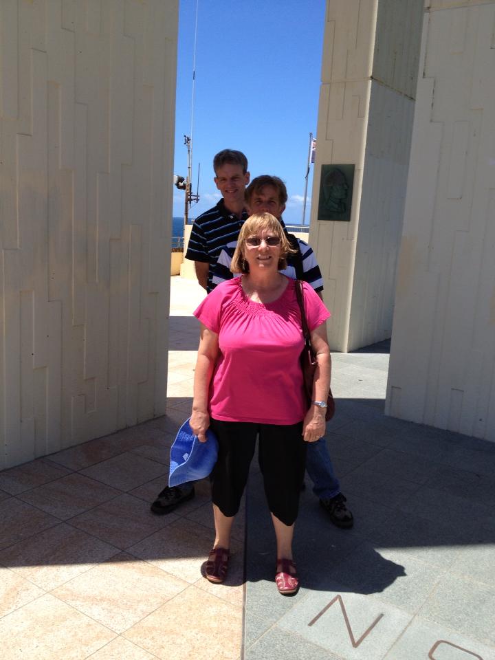 Rolanda, Col and Peter standing across the border of Qld and NSW at Point Danger