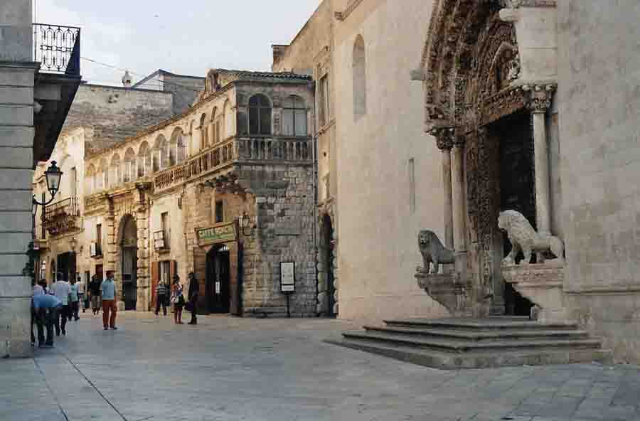 At the right is the entrance to the Cathrdral, with its guardian lions.  This is one of the main Old Town roads leading off the central piazza