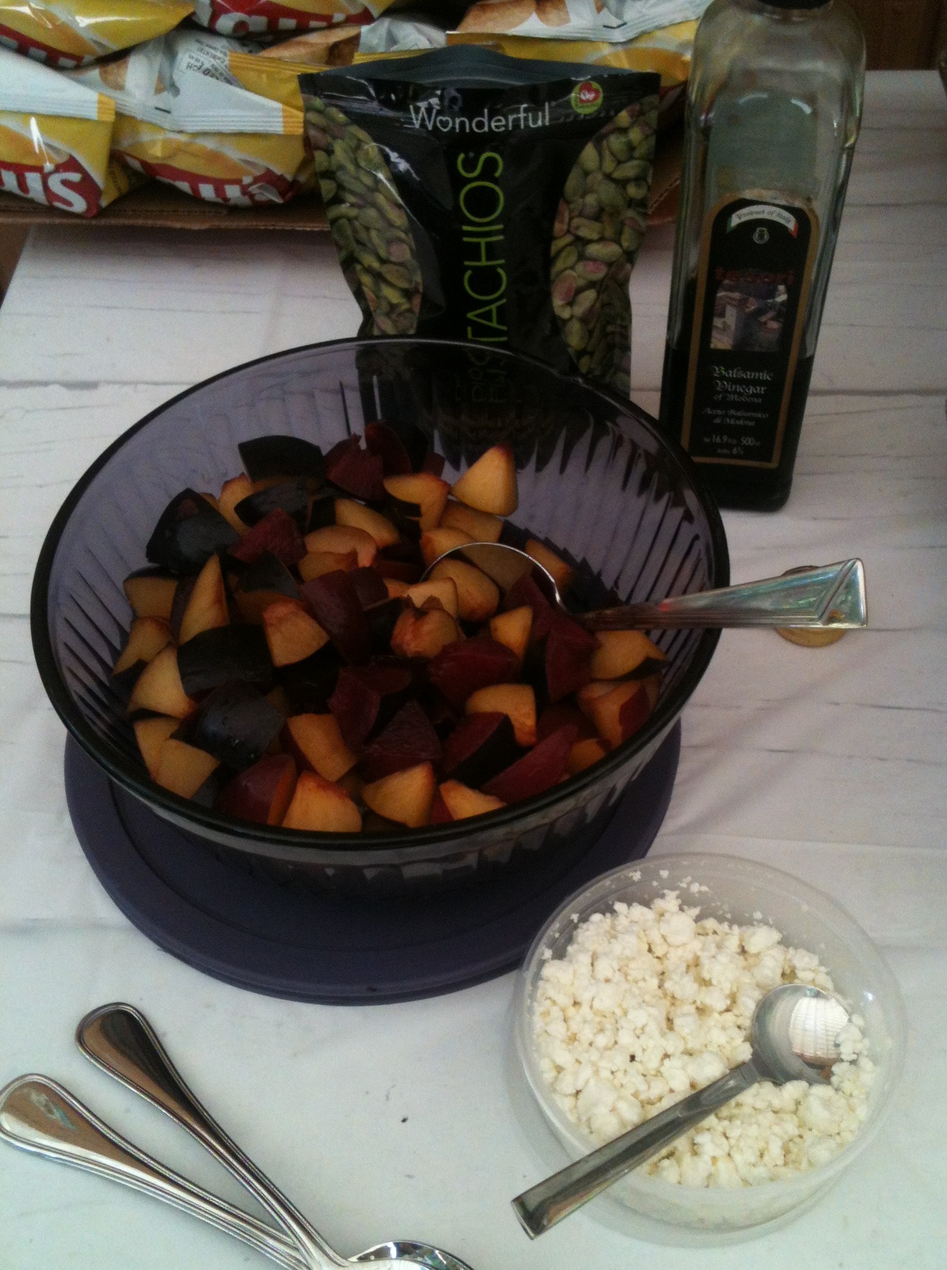 Mixed varieties of fresh plums, goat's milk cheese, pistachios and balsamic vinegar. It would have been better mixed and allowed to sit, but them some people may not have eaten the plain fruit.