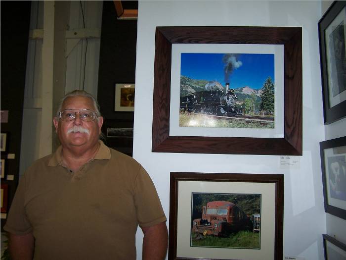 Here is my husband, Leon, standing next to his entry, "Heading to the Highline".  What an honor for him, too. This was taken on our trip to Colorado, and yes, the sky was really THAT blue!! I'll post a larger one of his photo on my gallery for your enjoyment, too.