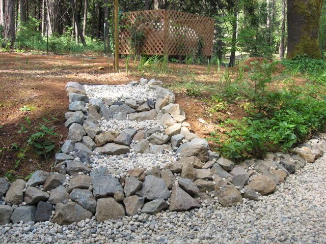 Building some rock steps up from the side of the garage to the upper yard area.