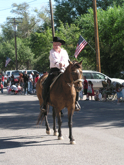 My 88 year old grandpa riding a horse in the parade.