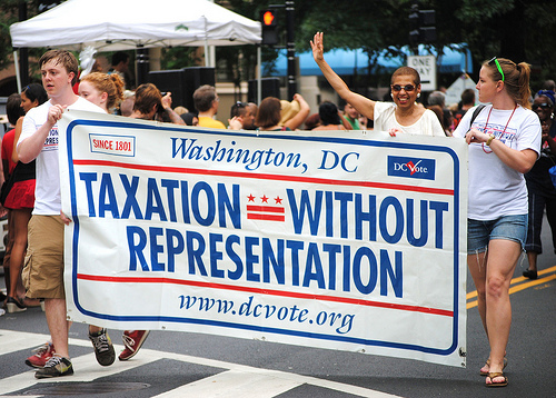 DC license plate slogan (which I suggested) with DC's non-voting Delegate to Congress, Eleanor Holmes Norton, waving to the crowd. 