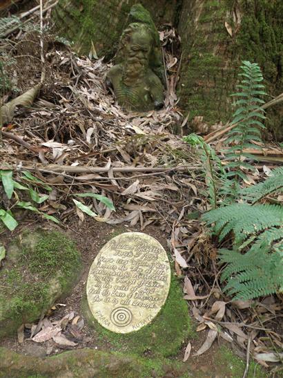 are buried beneath this plaque at the foot of a majestic tree.