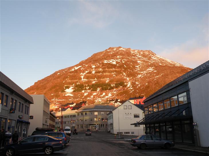 The sun drenched hillside had numerous snow fences.