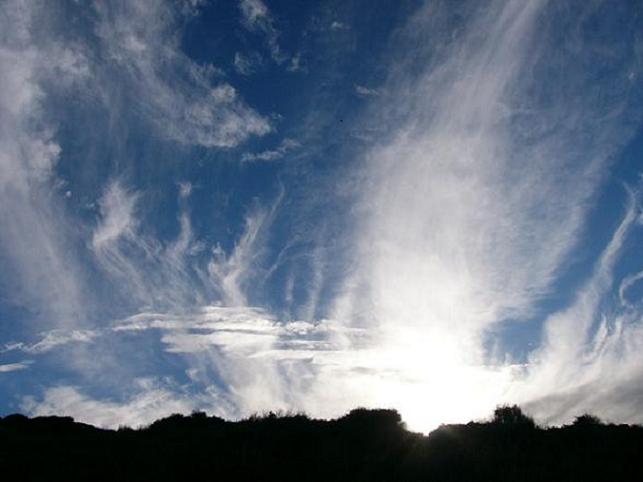 Cloud formation and sun going down behind the hills at Cosy Corner Beach, Albany