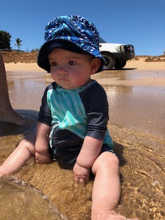 A bewildered look on his face but he loves going to the beach.