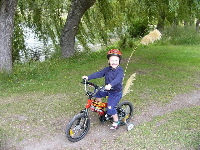 Johnathan riding his bike around the tracks at The Groynes on my second last day in Christchurch with his "fairy tail" (pampas grass) flags.