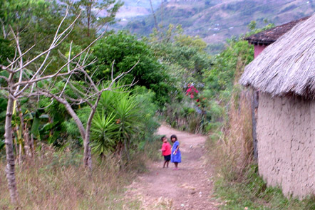 Two of the kids playing behind their house.  It was a very well kept village.