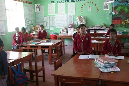 A classroom. About 20 students. More boys than girls.